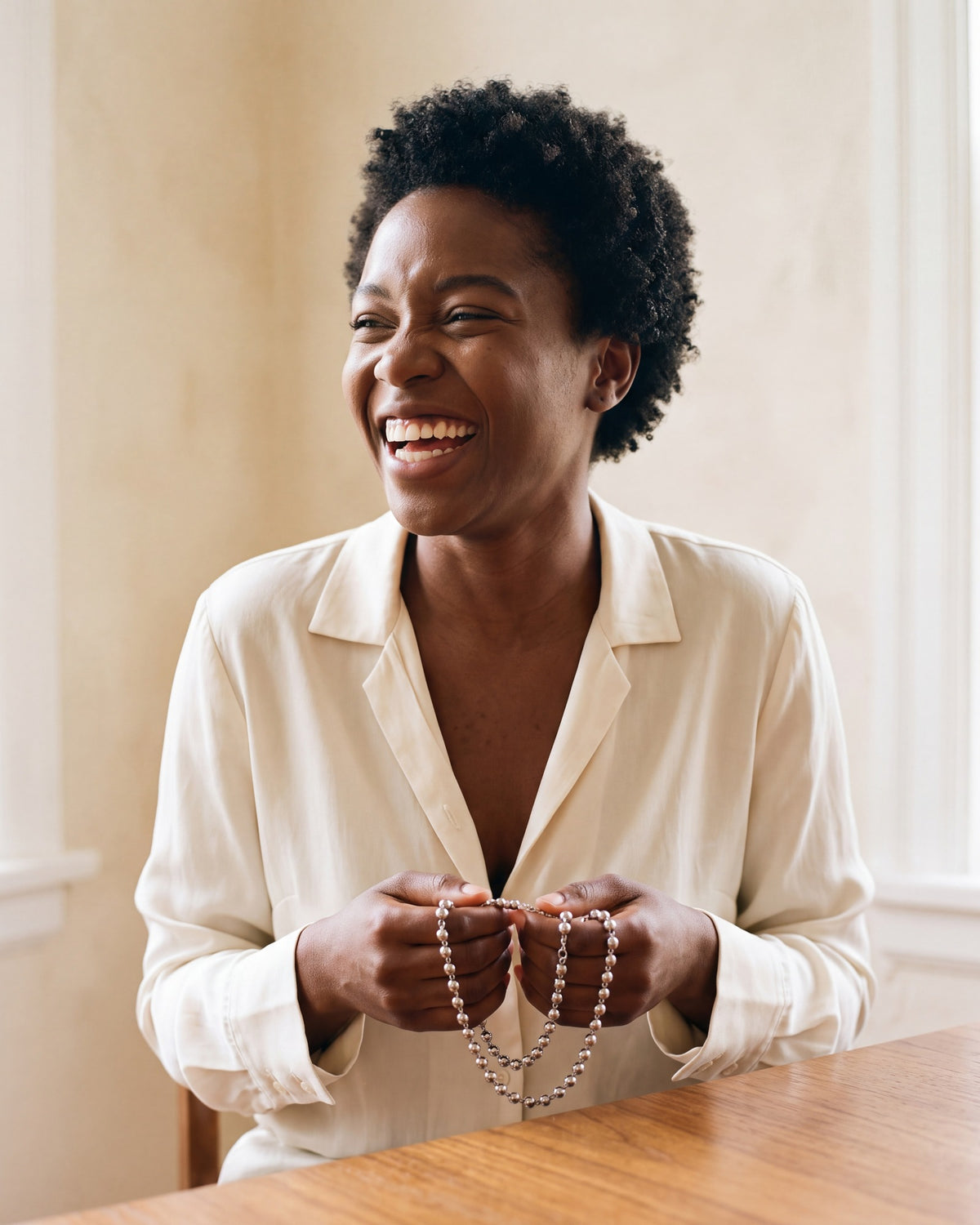 Smiling woman holding the silver Prayerful Journey in her hands [c:silver]