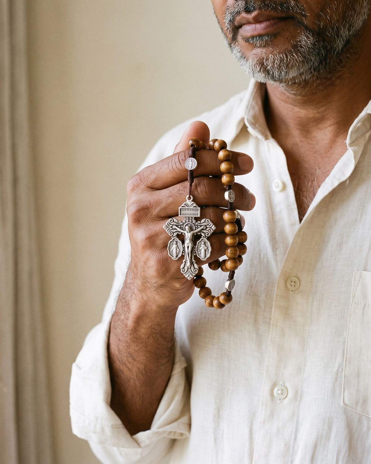 Hands holding the crucifix of The Prayerful Rosary [c:pardon-crucifix]