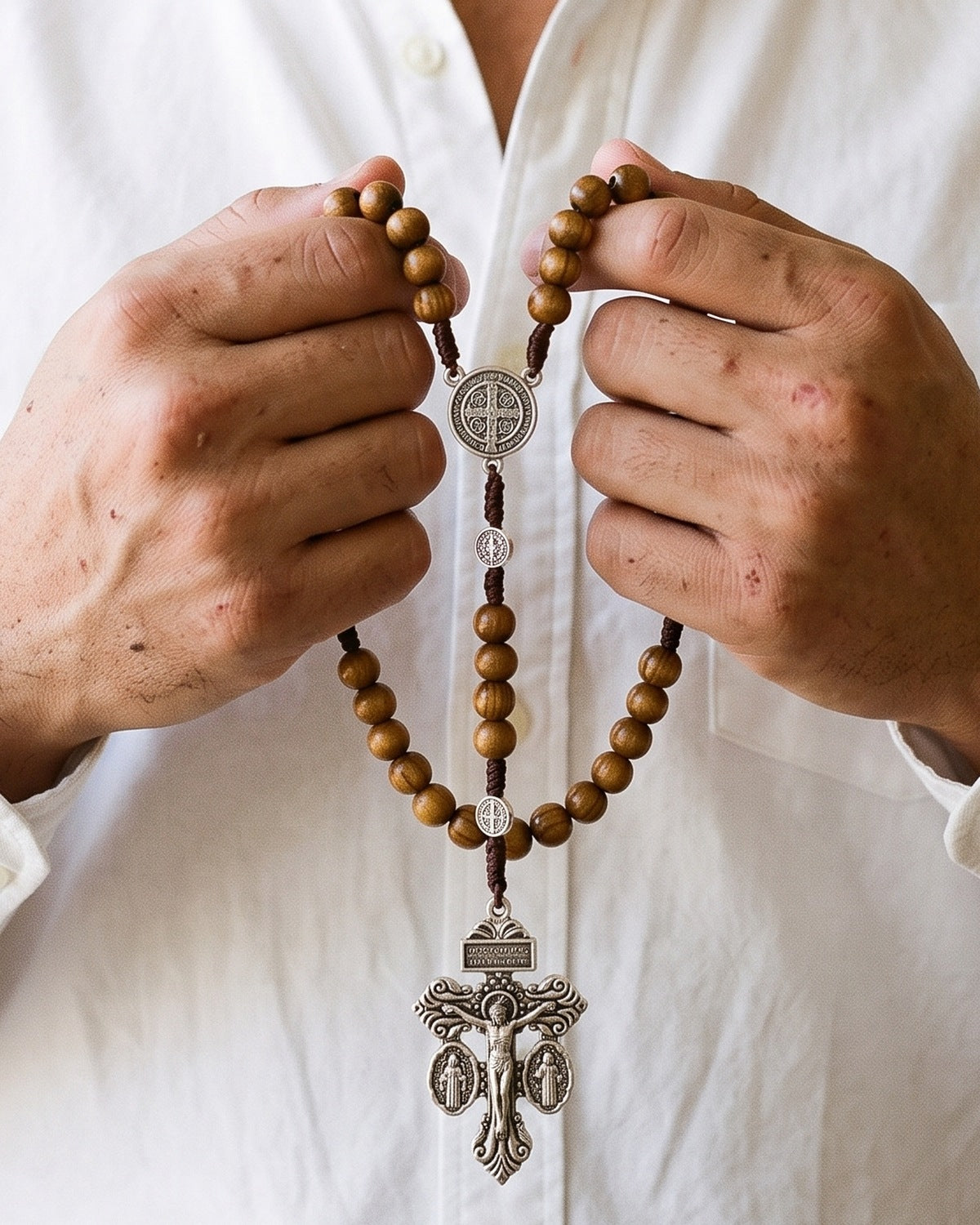 The Prayerful Rosary held in a man's hands, close-up [c:pardon-crucifix]
