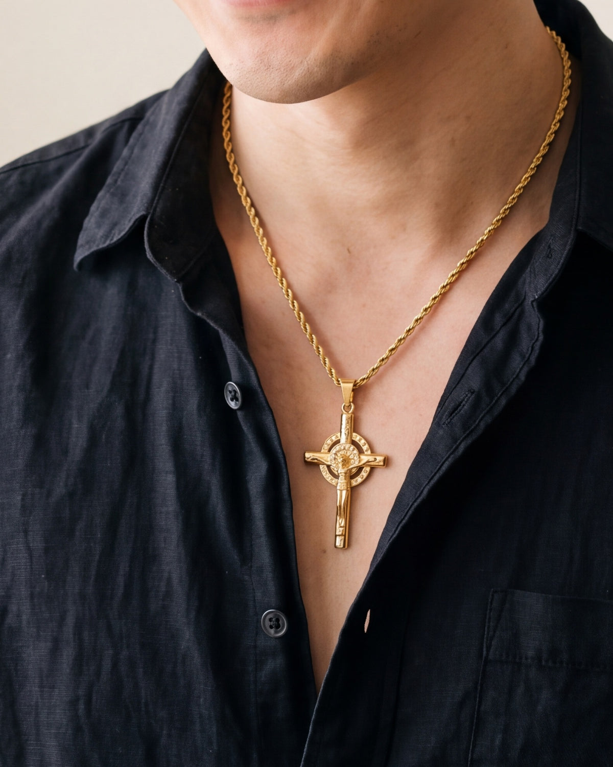 The Radiant Crucifix worn by a man, close-up from chin to chest, true to size