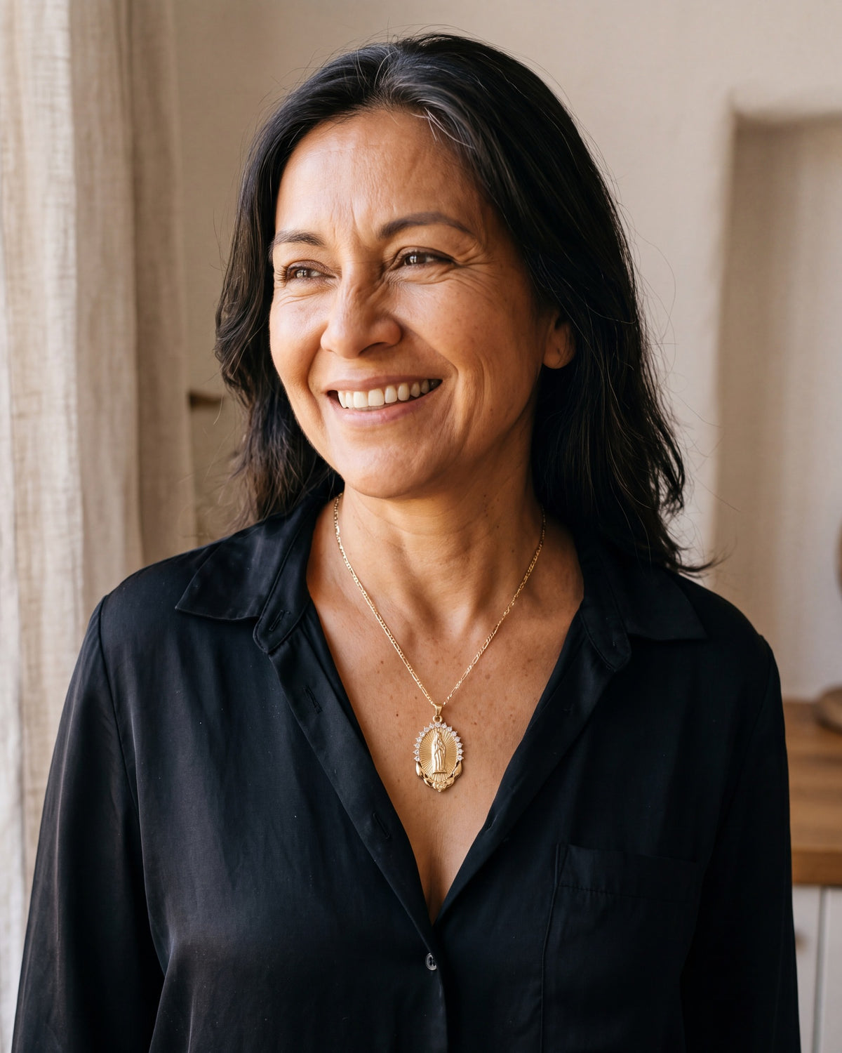 Smiling woman wearing The Radiant Madonna medal [c:gold]