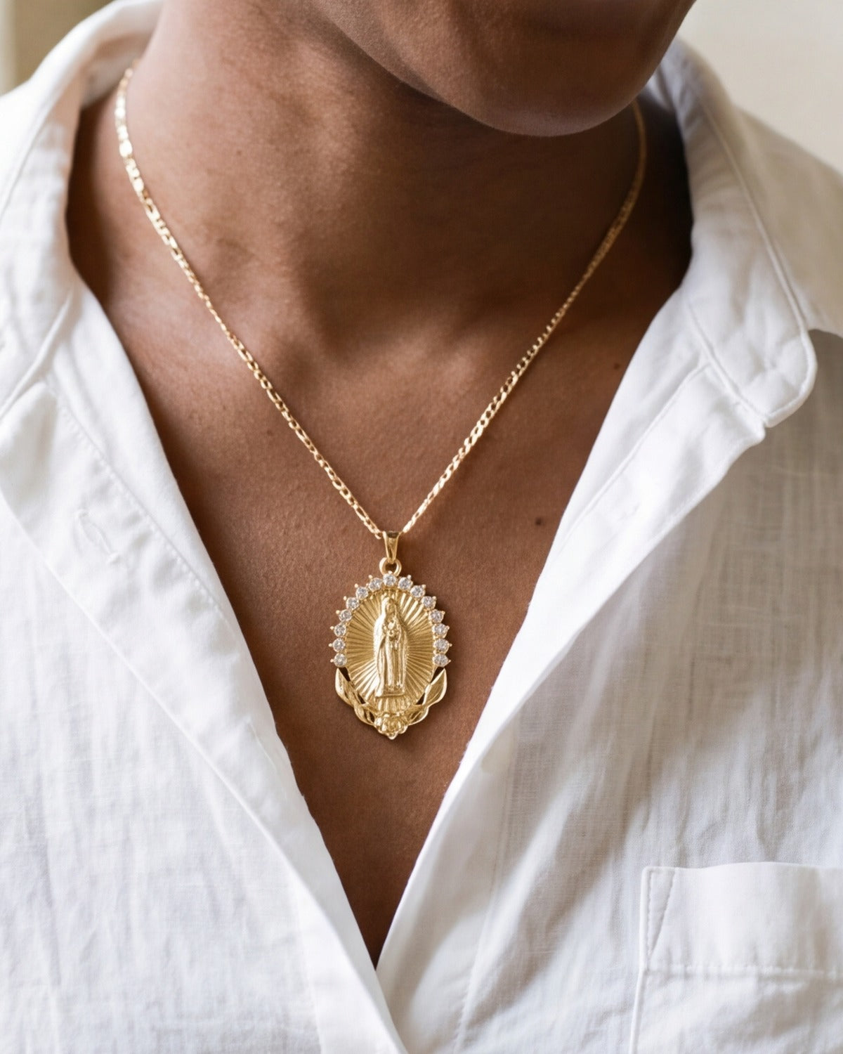 The Radiant Madonna medal worn by a woman, close-up from chin to chest, true to size [c:gold]