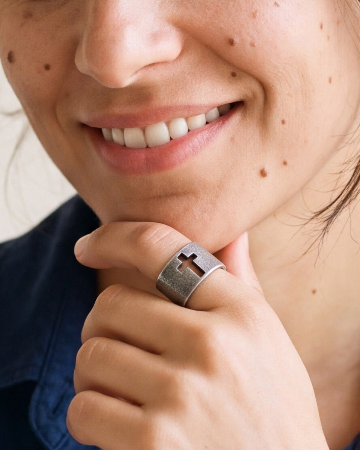 The Retro Cross ring worn, hand close-up, true to size