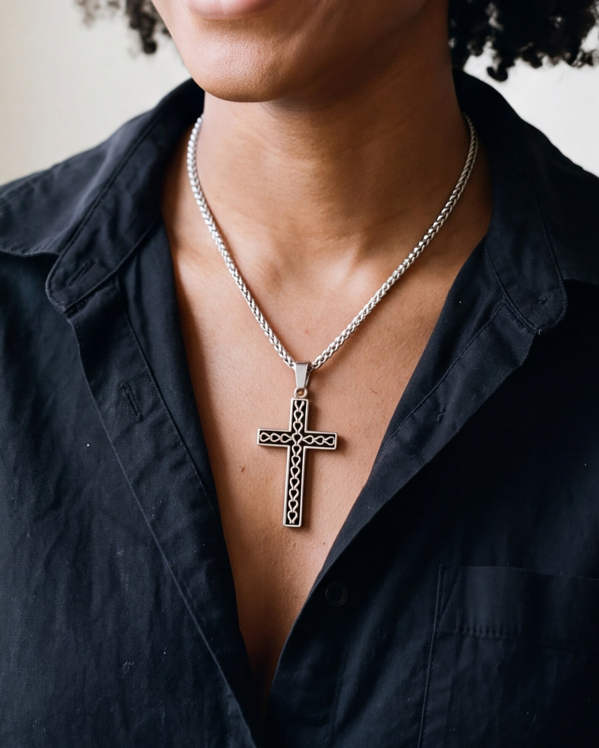 The silver Reverent Heart Cross worn by a woman, close-up, true to size [c:silver]