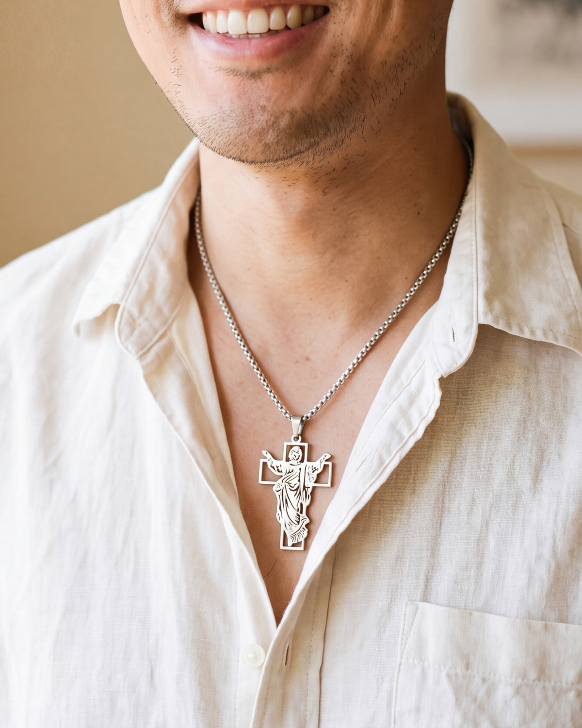 The silver Risen Christ worn by a man, close-up from chin to chest, true to size [c:silver]