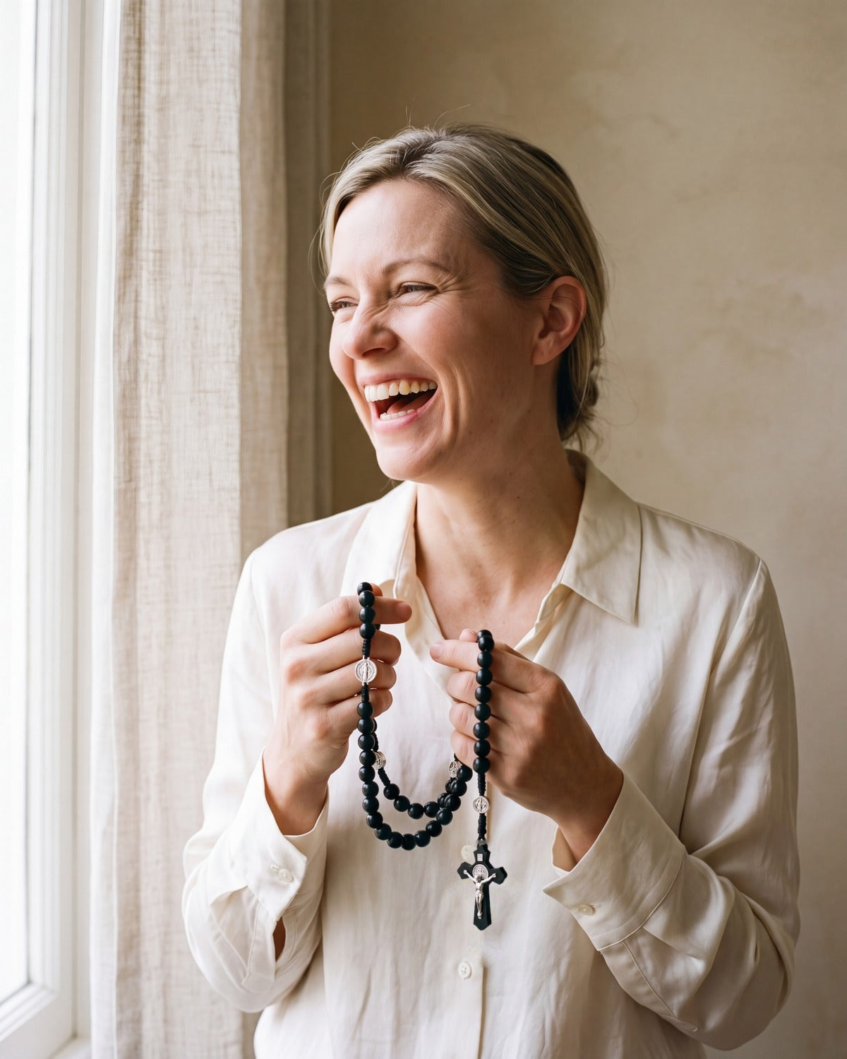 Smiling woman holding The Rosary of Faith [c:black-beads]