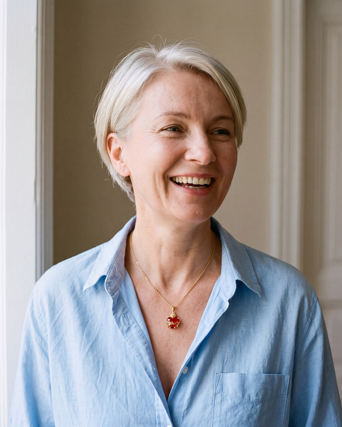 Smiling woman wearing the gold Sacred Heart Flame [c:gold]