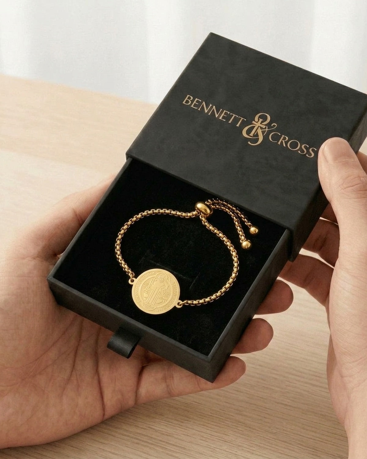 The Sacred Medal Bracelet in its black Bennett & Cross gift box