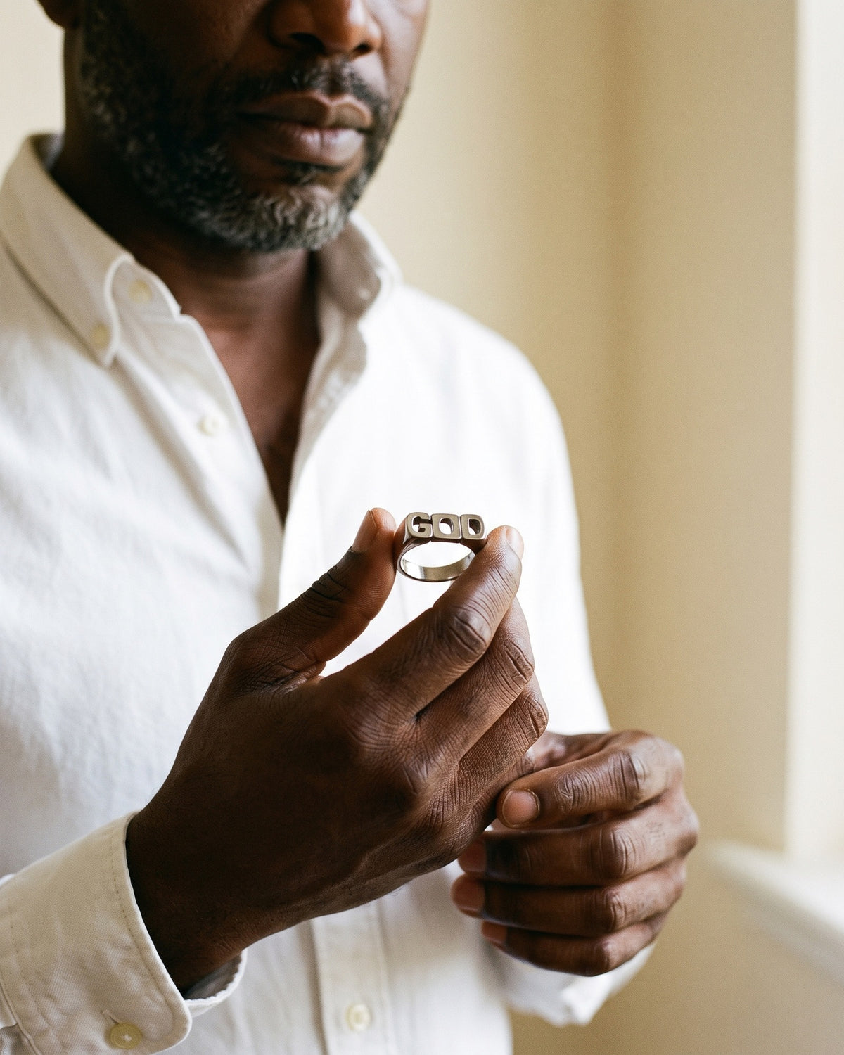 Man holding The Sacred Script between the fingers