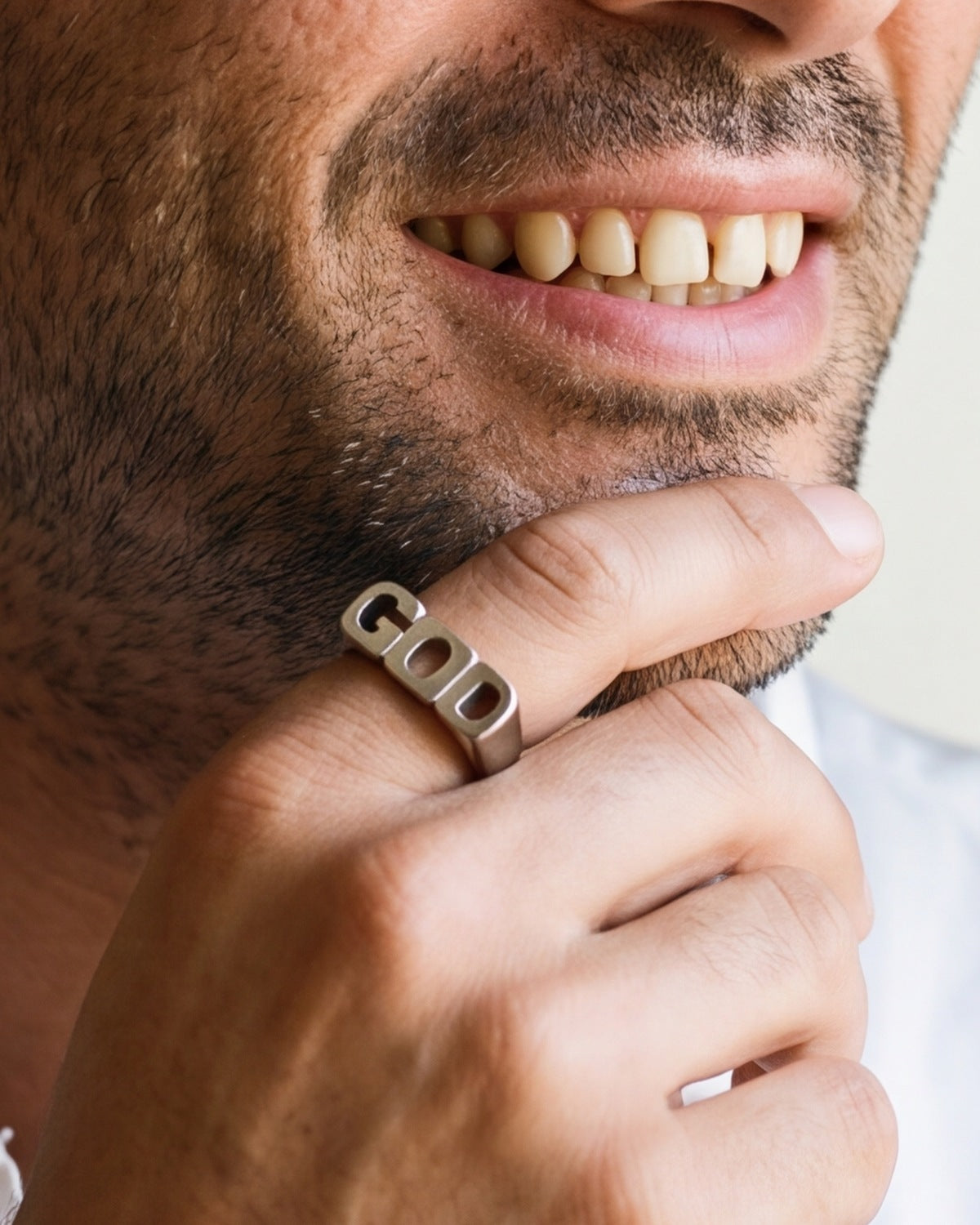 The Sacred Script on a man's finger, close-up, true to size
