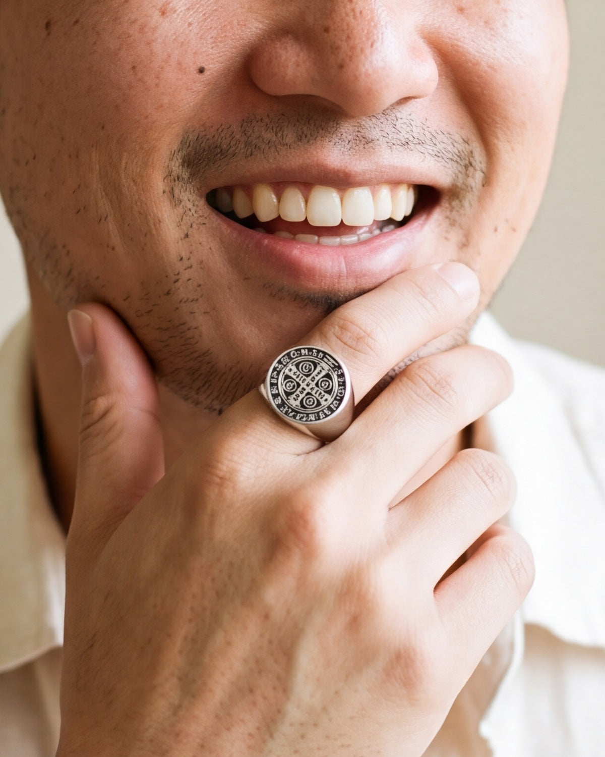 The silver Sacred Signet worn by a man, close-up, true to size [c:silver]