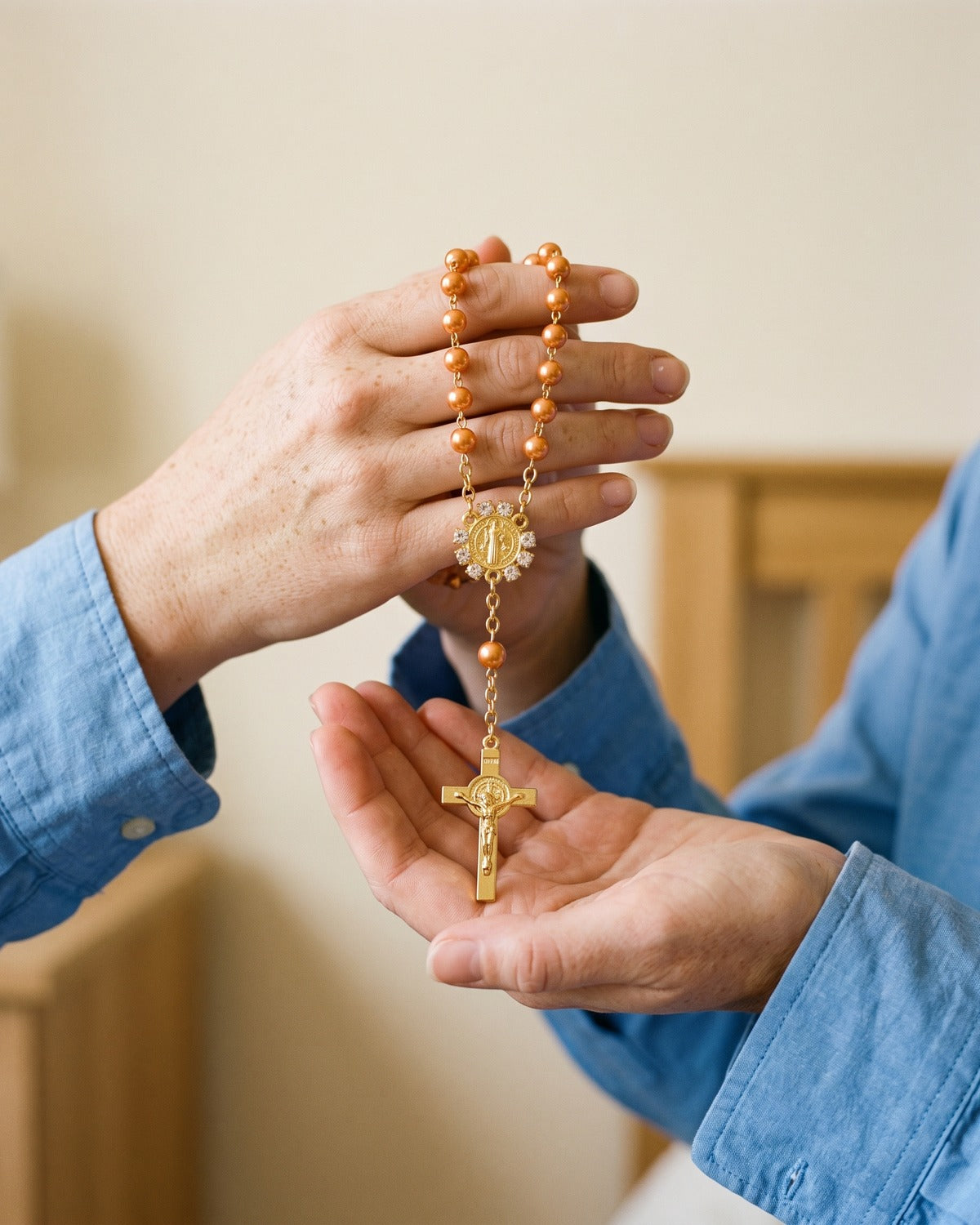 A woman's hands holding the Saint Benedict Decade rosary, true to size [c:orange]