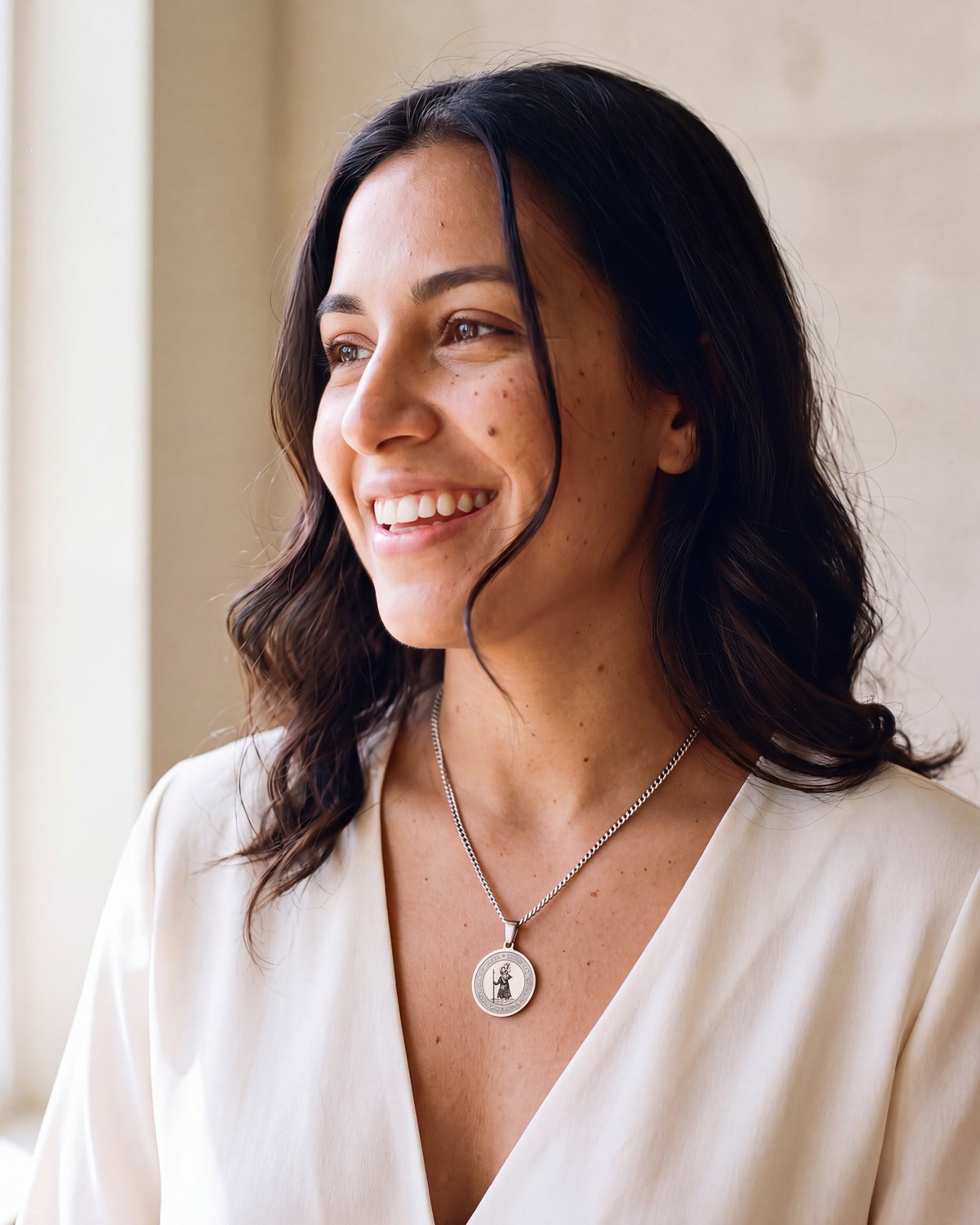 Smiling woman wearing the silver Saint Christopher Medal [c:silver]