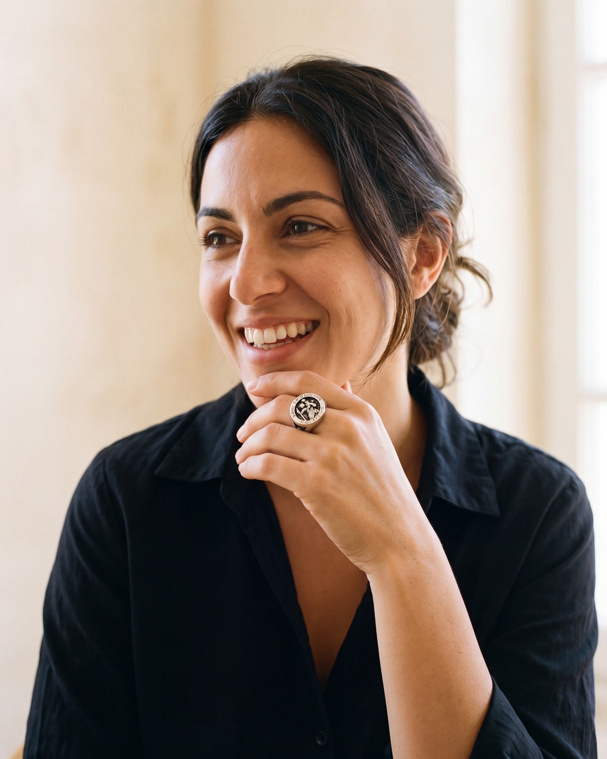 Smiling woman wearing The Saint Christopher Signet ring