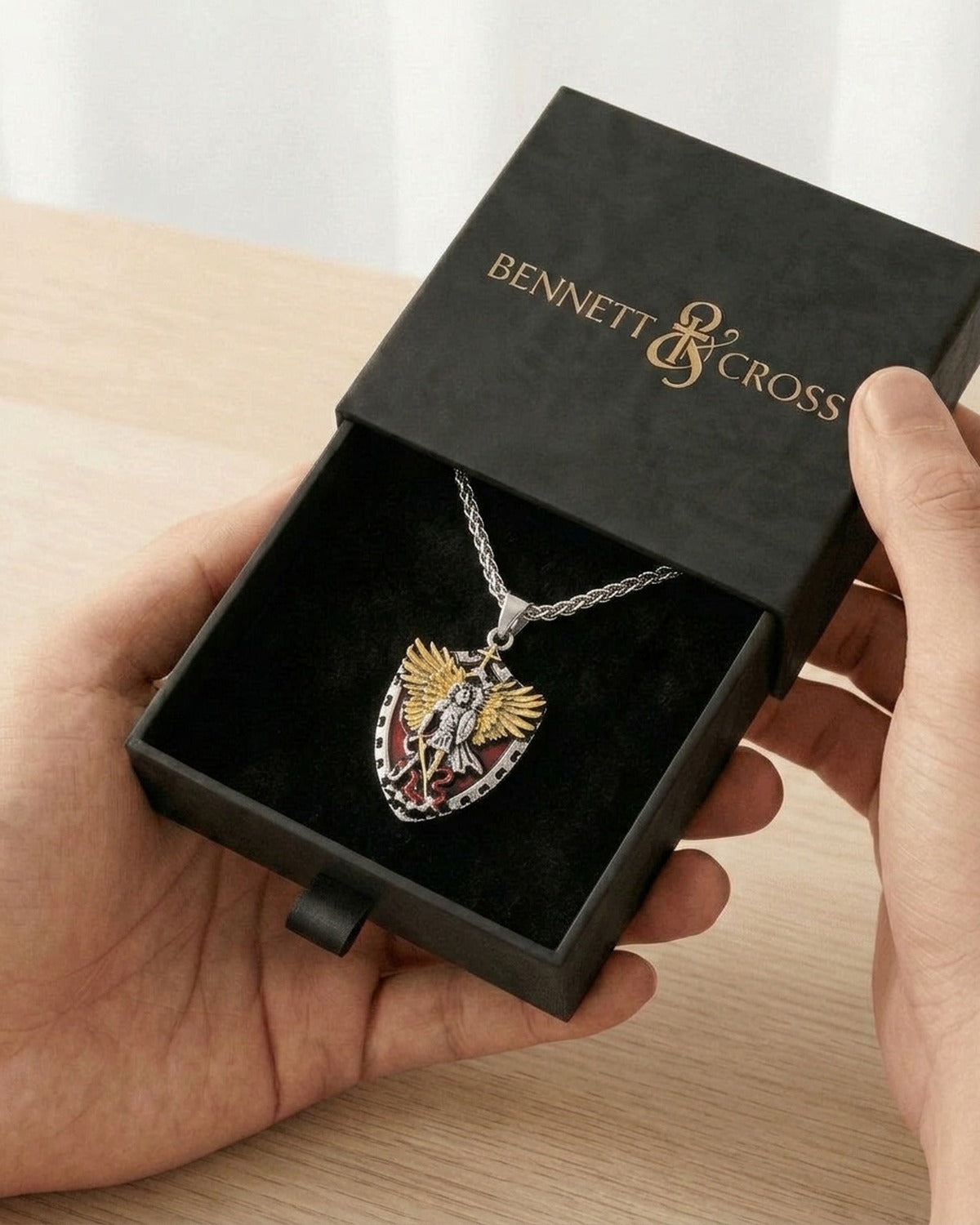 The Saint Michael Crest in its black Bennett & Cross gift box