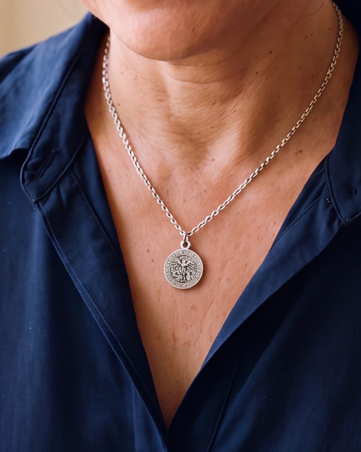 The Saint Michael Prayer worn by a woman, close-up, true to size [c:antique-silver]