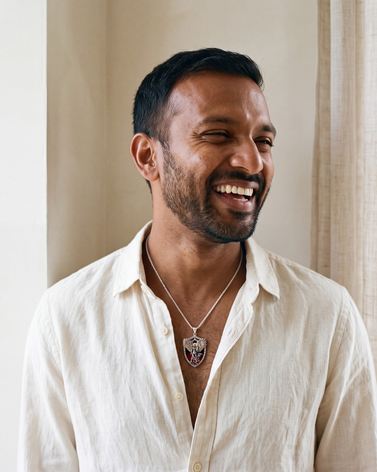 Smiling man wearing The Saint Michael Shield pendant