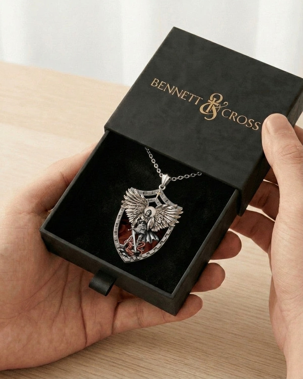 The Saint Michael Shield in its black Bennett & Cross gift box