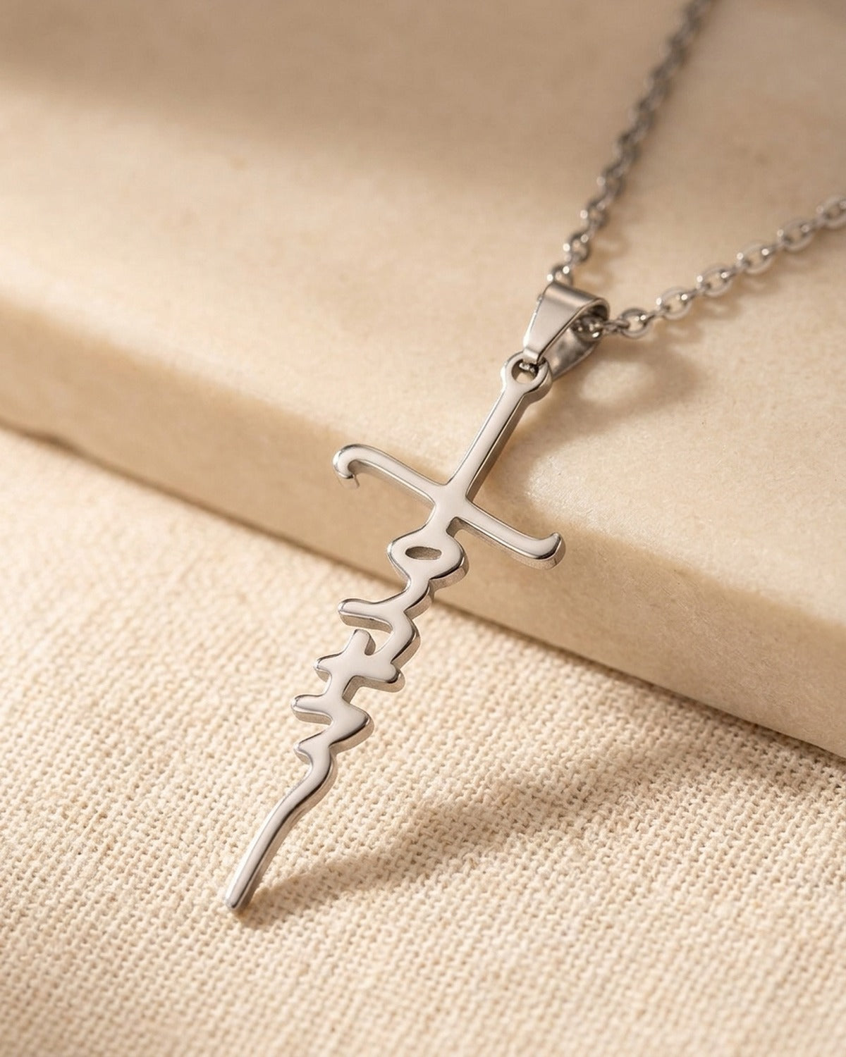 The Scripted Cross faith pendant held in the hand, true to size [c:silver]