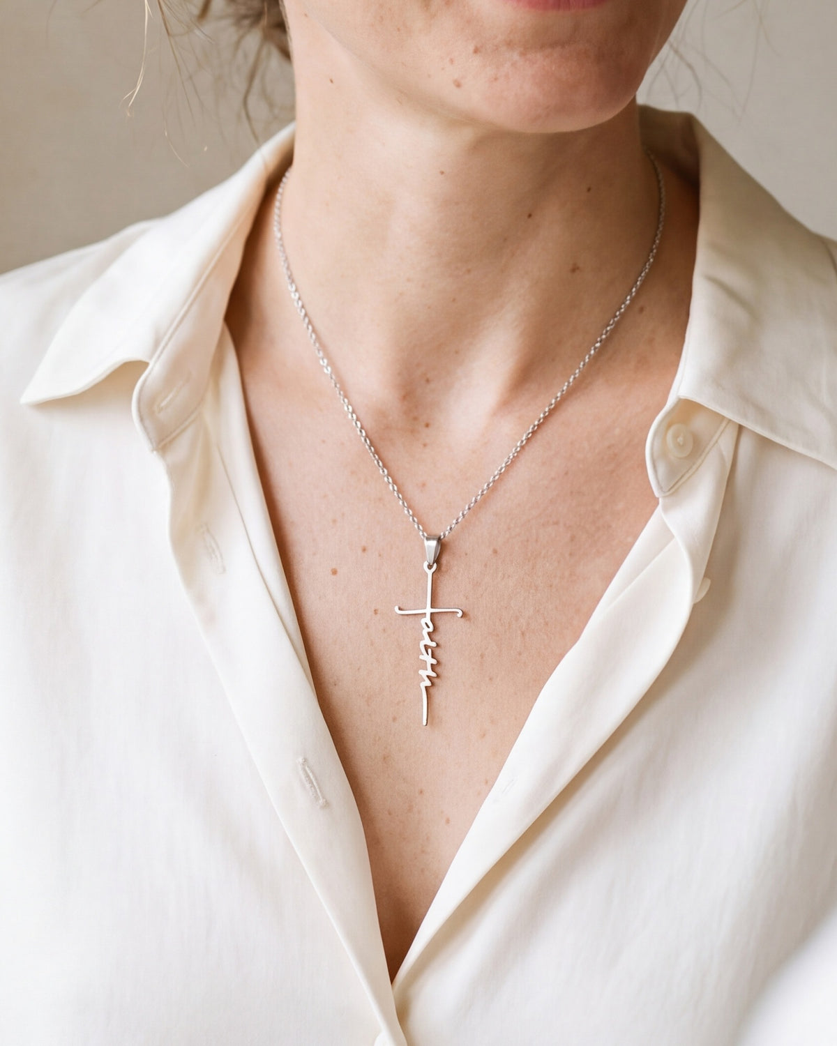 The Scripted Faith worn by a woman, close-up from chin to chest, true to size [c:silver]