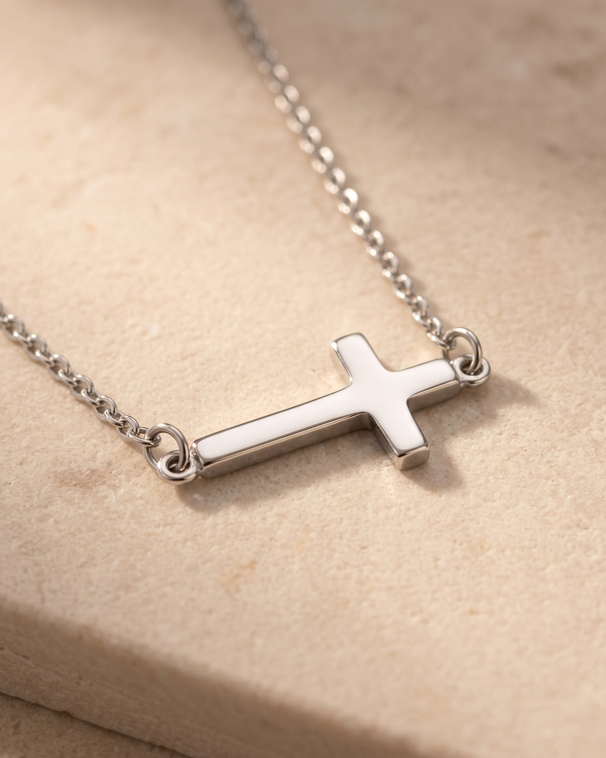 Detail of The Sideways Cross and its fine chain [c:silver]