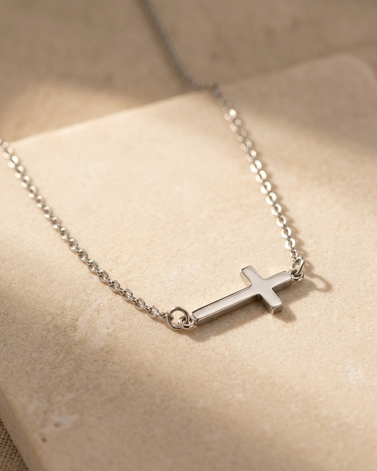Close-up of The Sideways Cross necklace [c:silver]