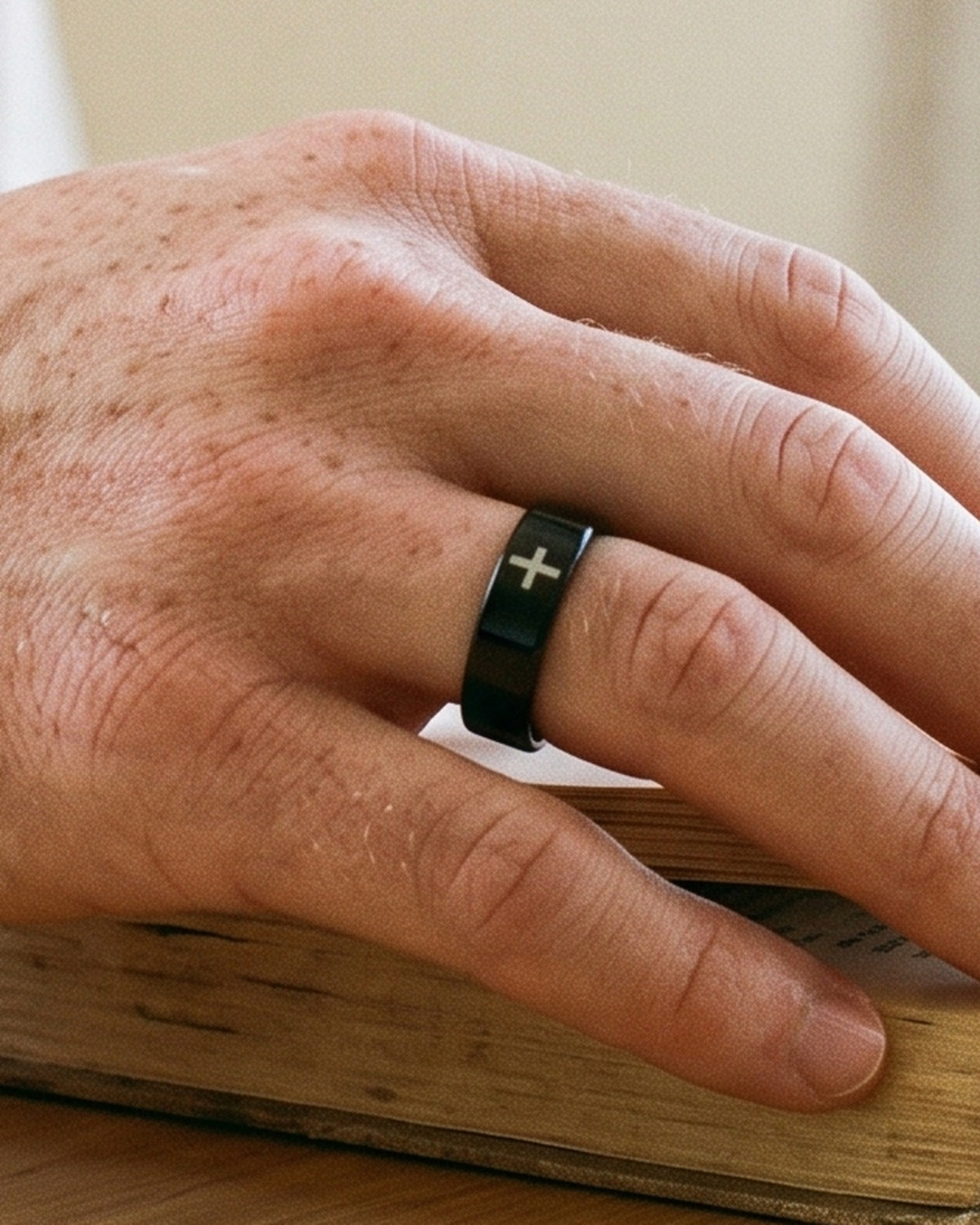 The Steadfast Bond on a man's finger, close-up, true to size