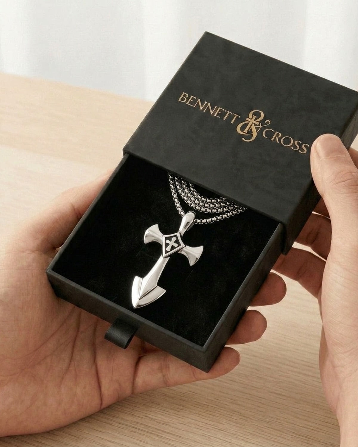 The silver Valiant Cross in its black Bennett & Cross gift box