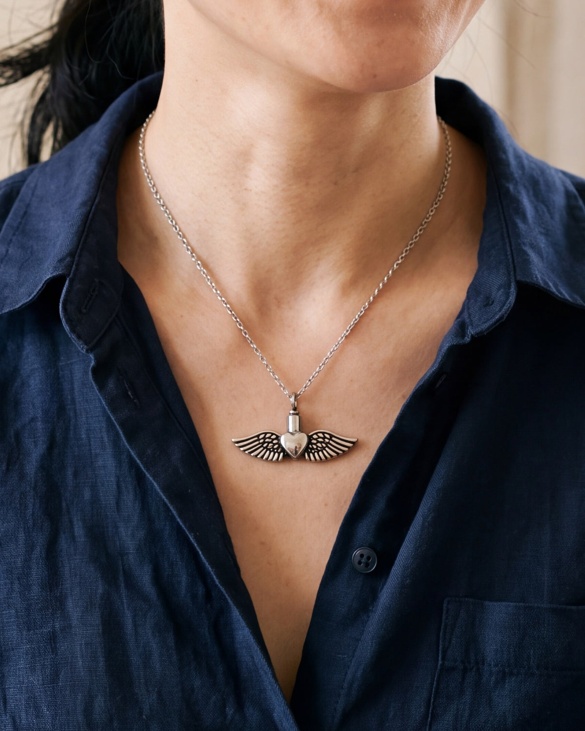 The Winged Heart necklace worn, second close-up, true to size