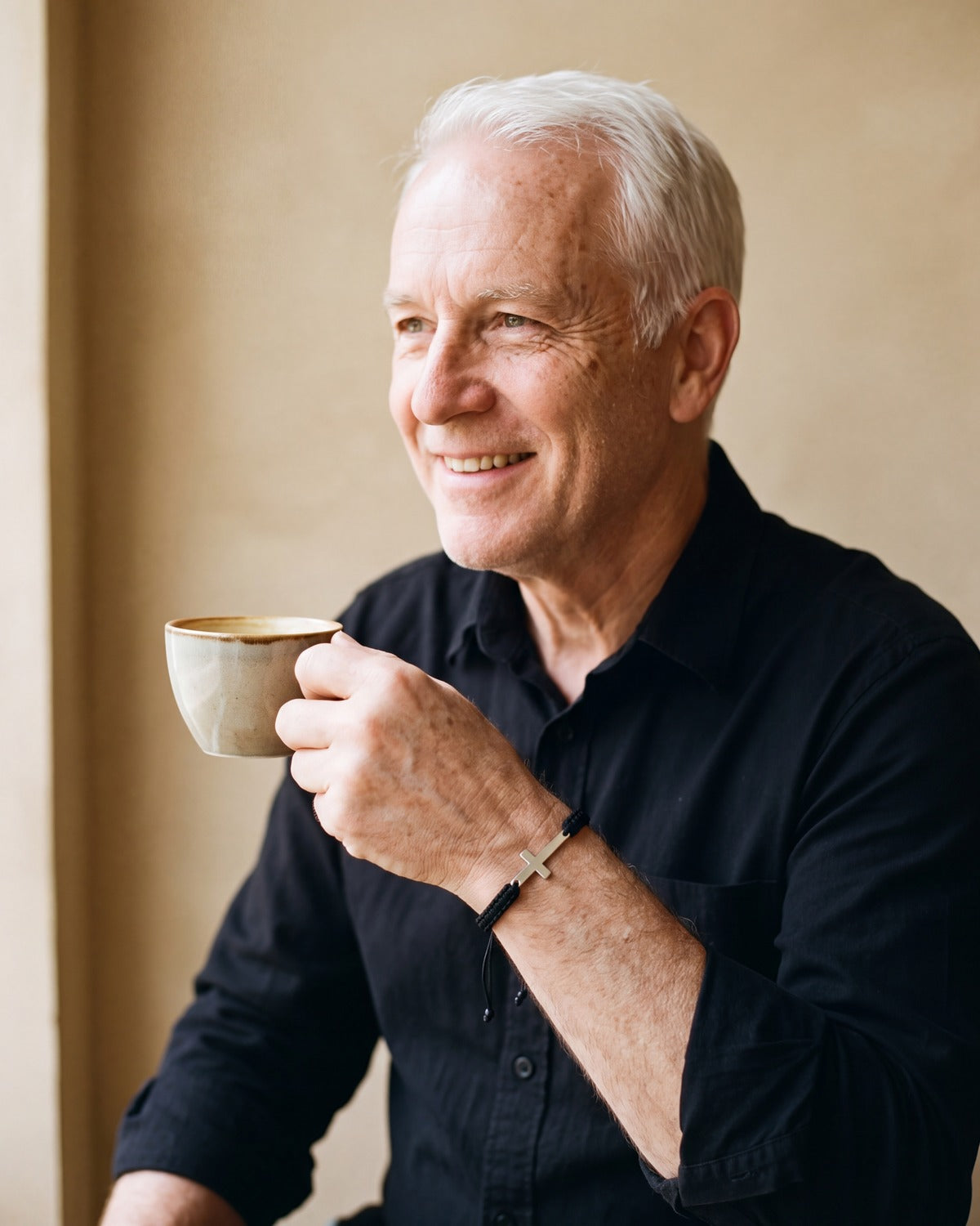 Smiling man wearing The Woven Devotion on the wrist [c:black]