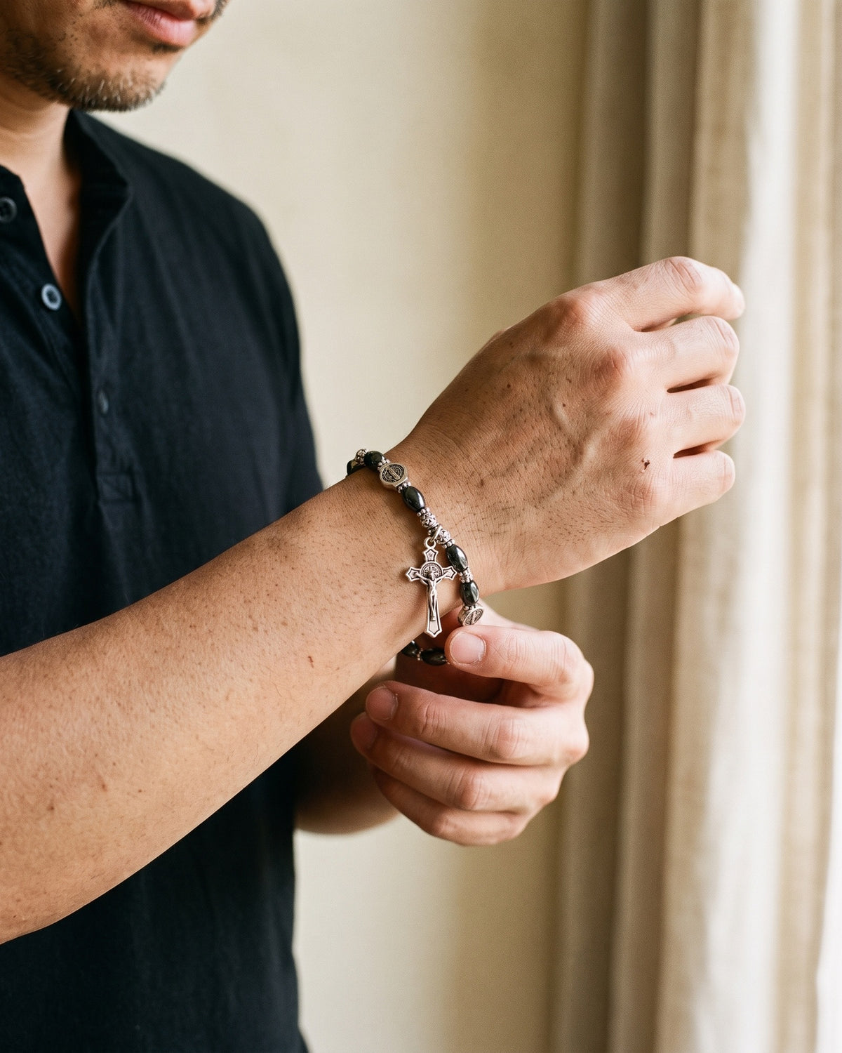 Man adjusting The Wrist Decade on the wrist [c:saint-benedict-shield]